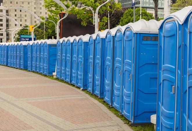 a line of brightly-colored portable restrooms, perfect for outdoor festivals and concerts in Burleson, TX